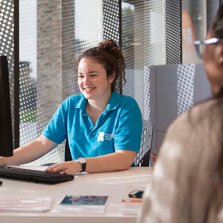 Support staff at desk on a computer 